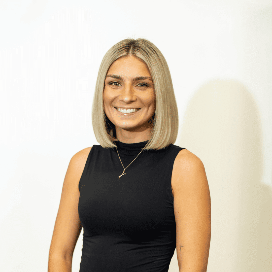 Portrait of Calista Issel, a professional stylist at Brown & DeLine Salon, showcasing their expertise and style.